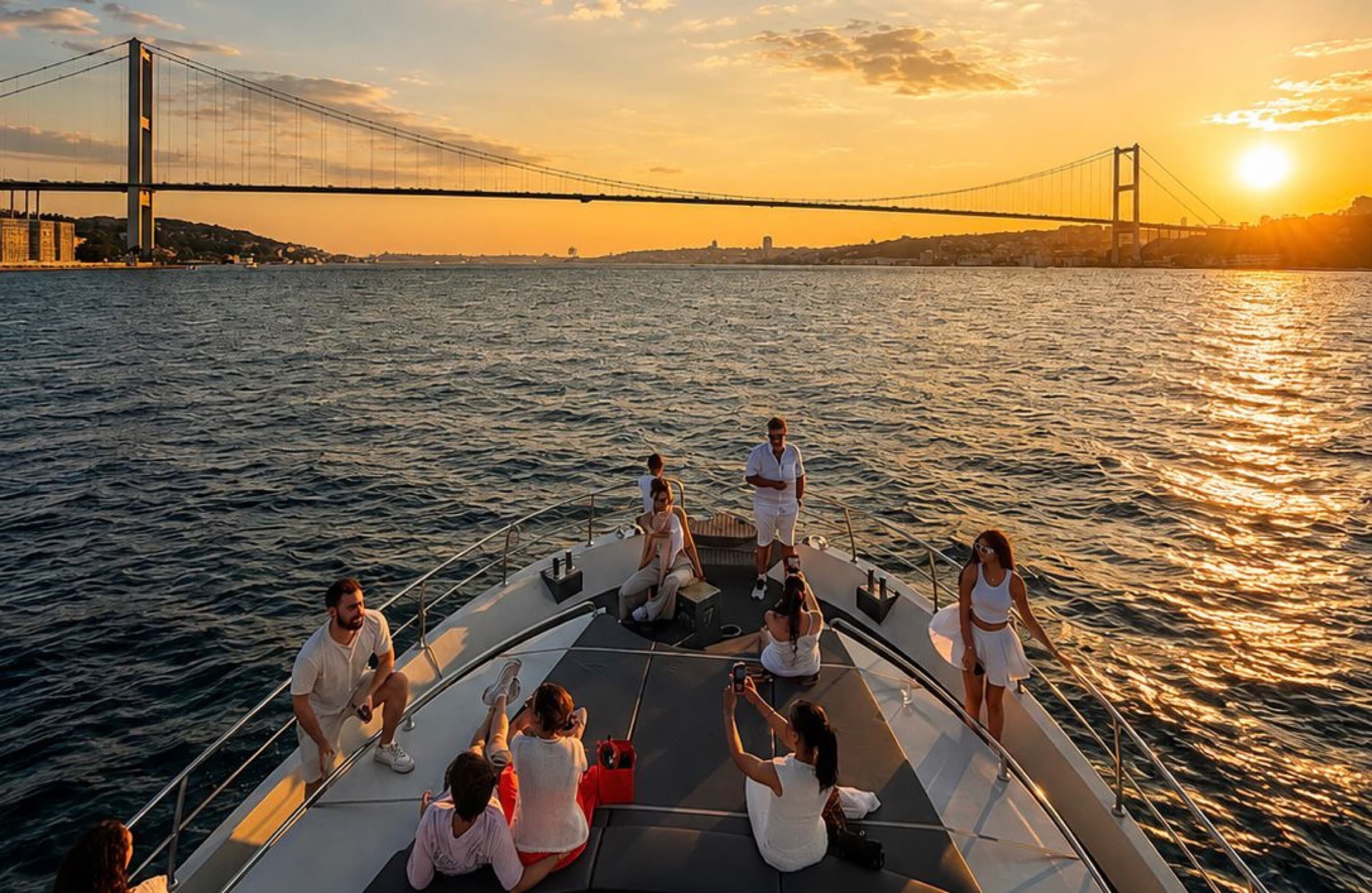 Guests on the bow at sunset, Bosphorus Bridge overhead