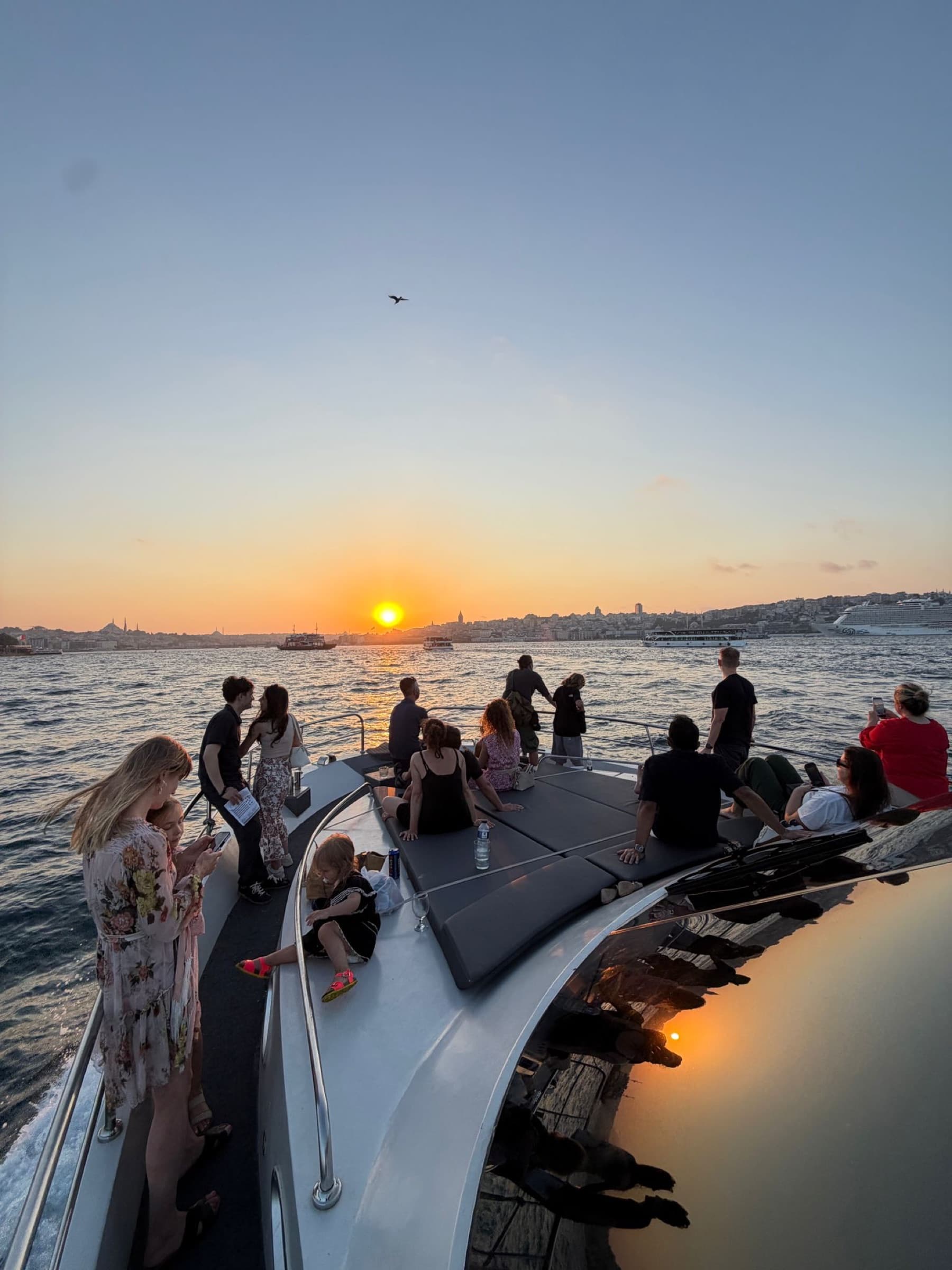 Sunset over the Bosphorus with the boat full of guests