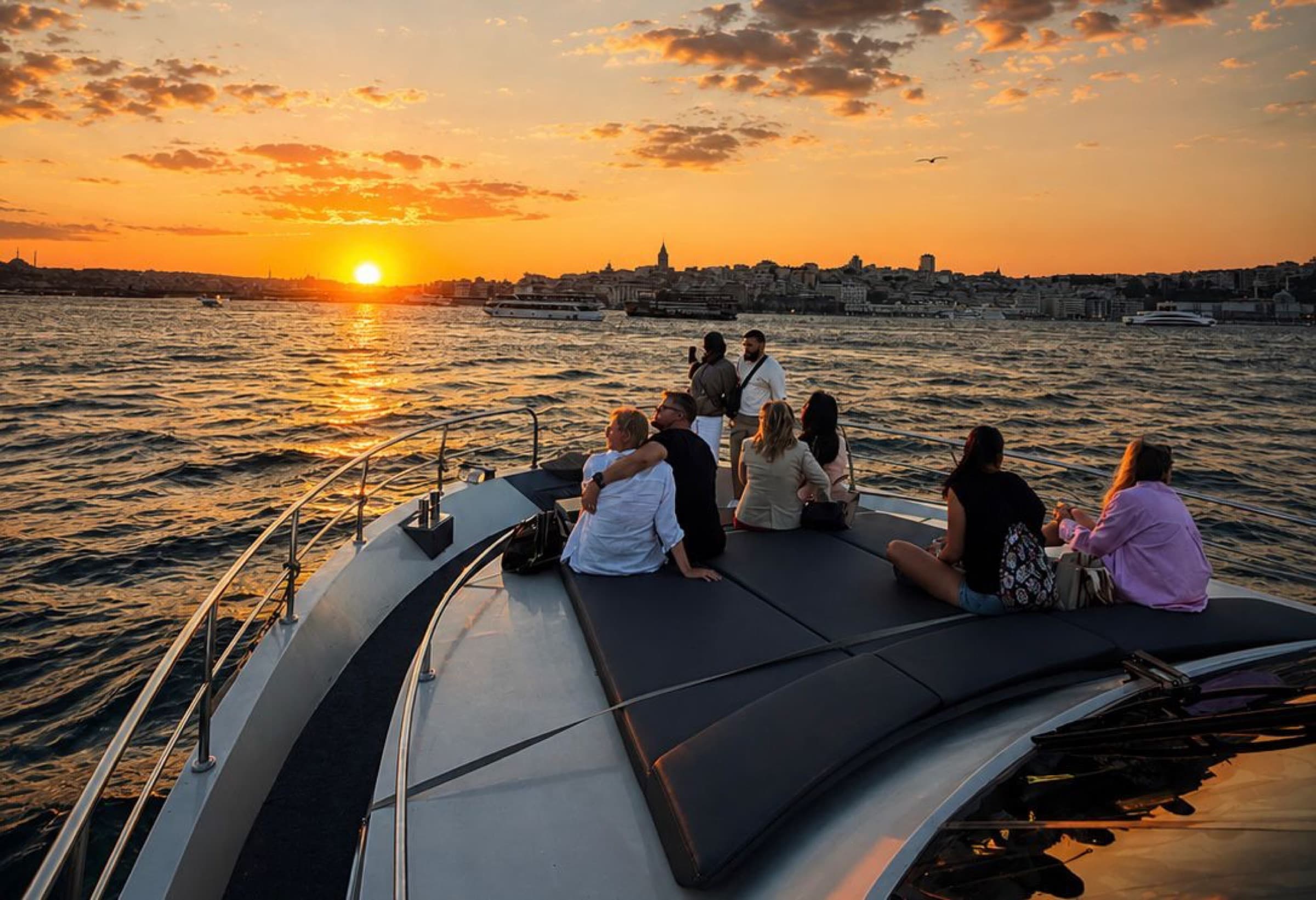 Sunset over the Golden Horn from the bow, guests taking photos