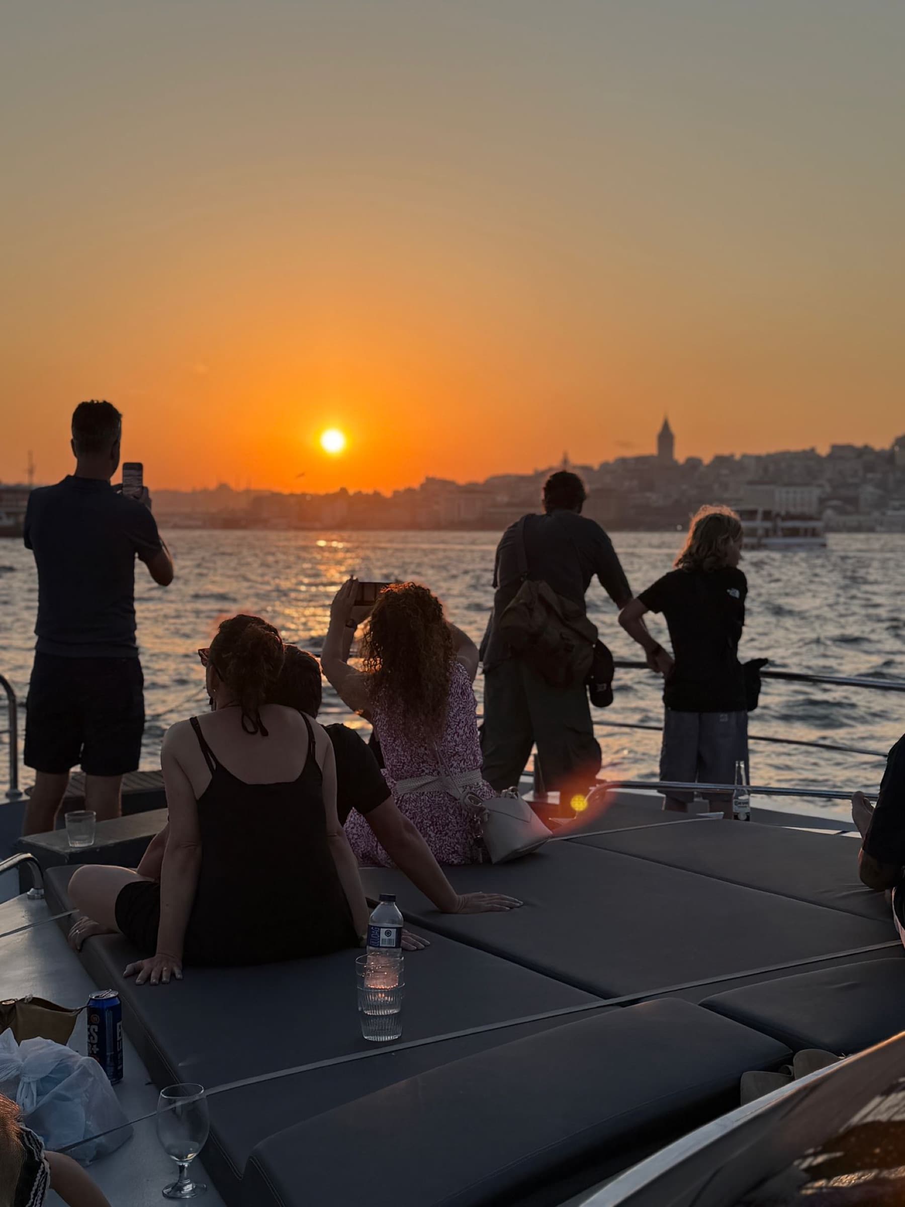 Guests capturing the sunset from the bow