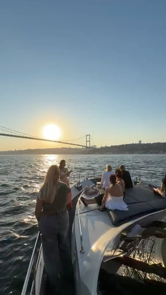 Passing a cruise ship on the Bosphorus, guests watching from the bow