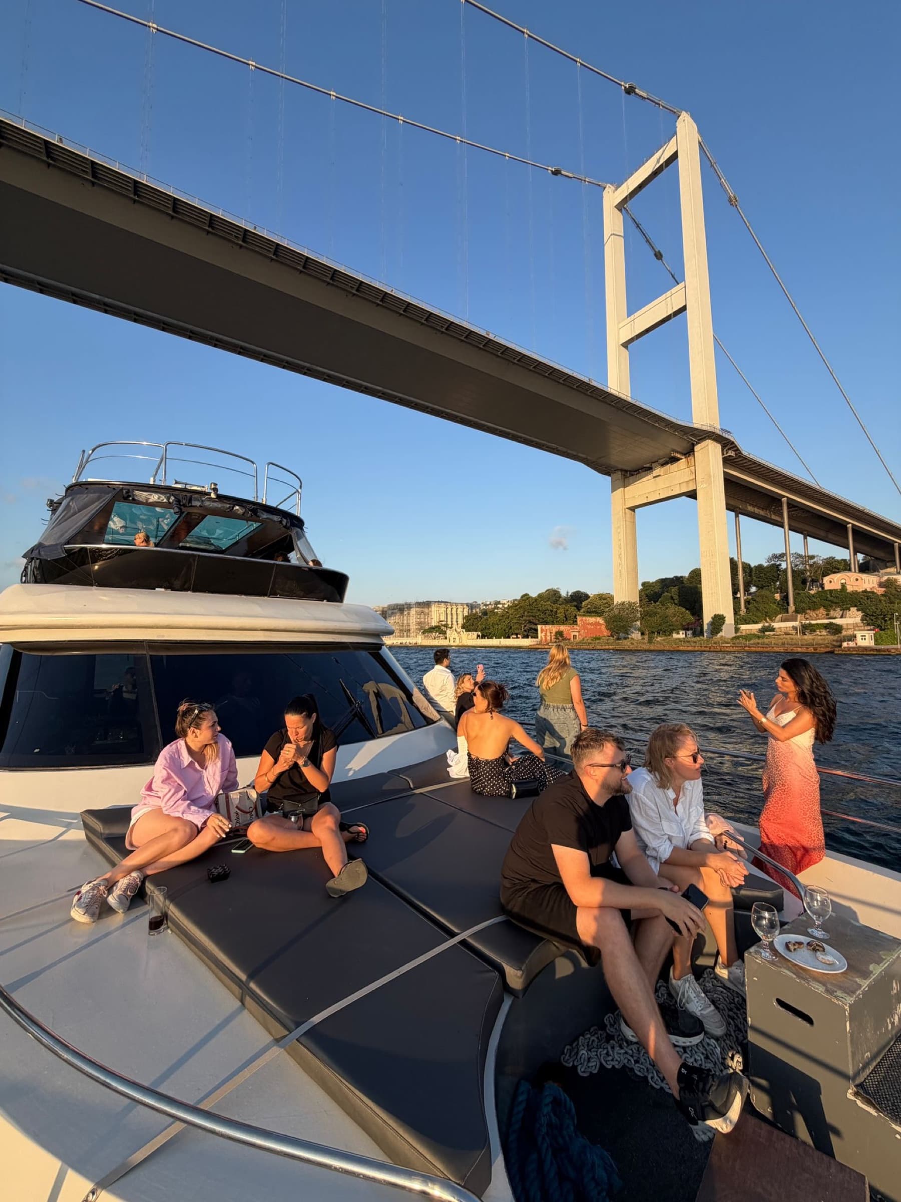 Small group on the bow, bridge tower overhead